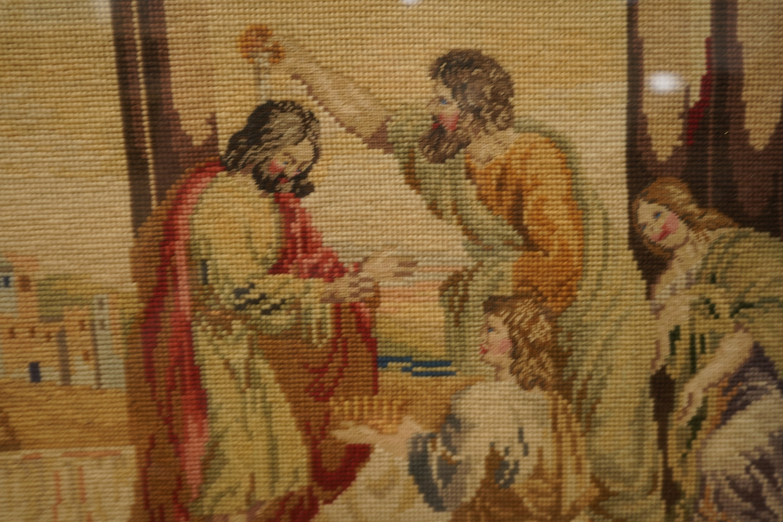 Two Victorian woolwork embroideries, one depicting Christ, the other John the Baptist both in carved gilt frames, largest 82cm high x 66cm wide
